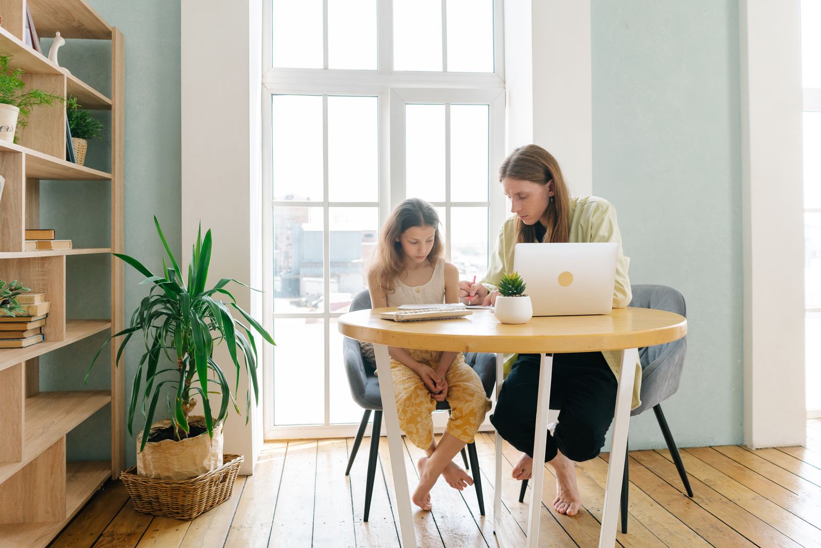A parent and child discover the dictation app on a laptop